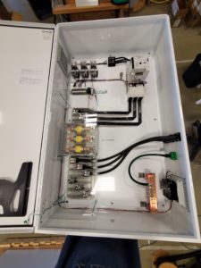 alt="electrical enclosure with the door open to show wiring and assembly"" 